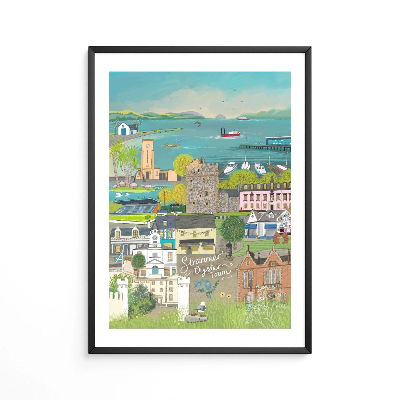 A framed art print featuring a colorful, hand-drawn illustration of Stranraer town with buildings, a harbor, and boats.