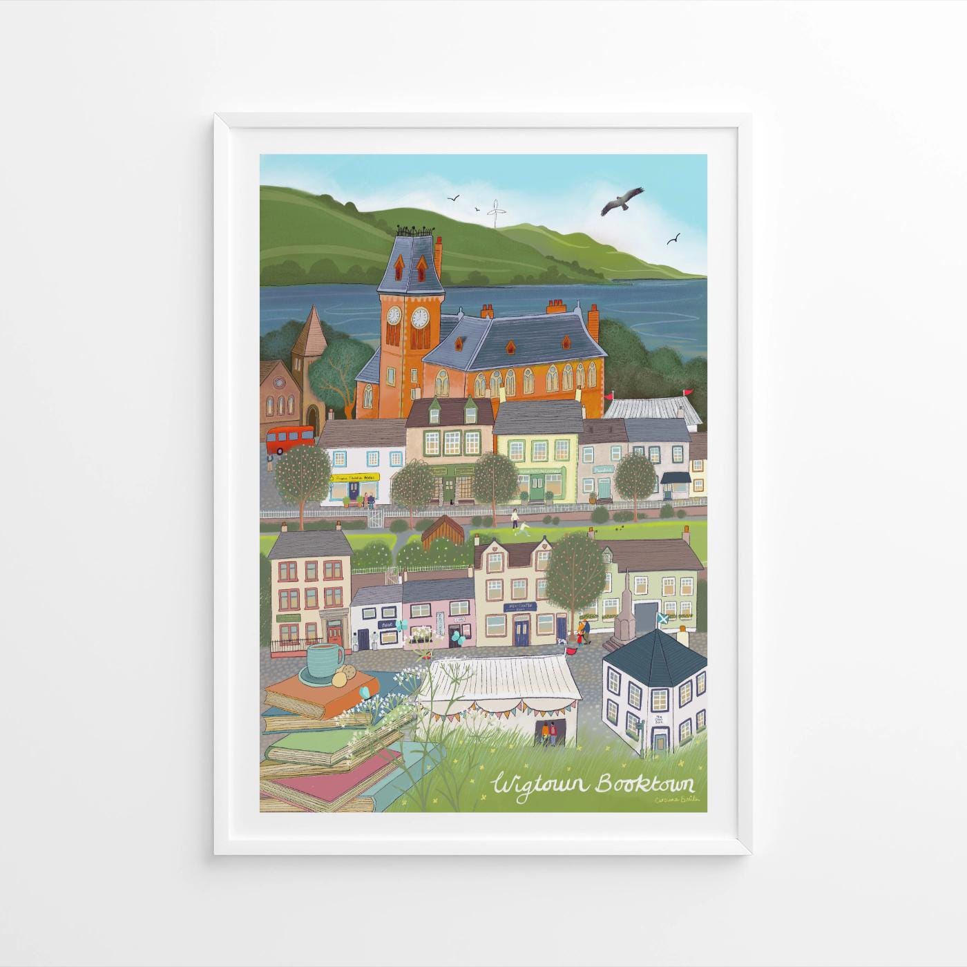 Framed artwork of a colorful village scene with a clock tower.