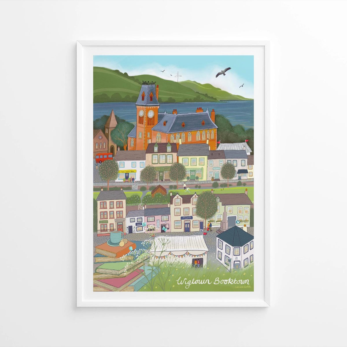 Framed artwork of a colorful village scene with a clock tower.